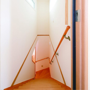 階段はそのまま活かし、クロスの壁をルナファーザー＋ホタテ漆喰に塗り替え。<br>
断熱・気密・遮音性能を保つため、厚い断熱ドアで間仕切りする