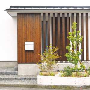 玄関前の木製の格子がアクセントに