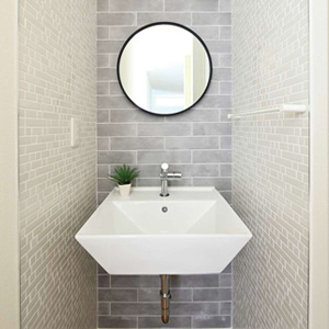 来客も使う1階洗面は2種類のタイルでセンスよく。